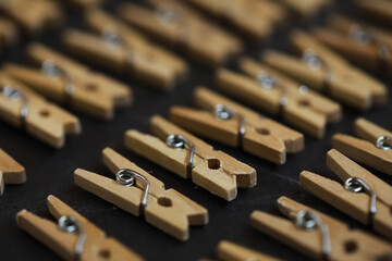 Wooden Clothespins Pattern on Dark Surface - Minimalist Design Stock Photo