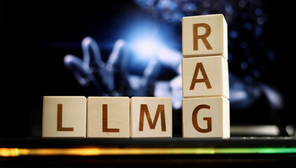 Blocks displaying the letters RAG and LLMG sit in front of a blurred background featuring hands reaching out, illustrating the interaction of technology and artificial intelligence