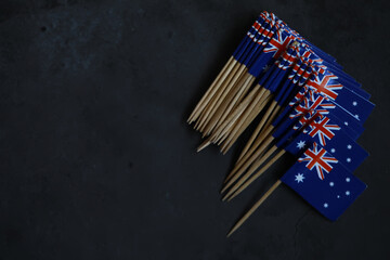 Cluster of Mini Australian Flags on Dark Background Celebrating National Pride and Identity
