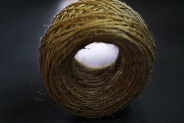 Close-Up View of a Jute Twine Roll on Dark Surface Highlighting Texture and Details