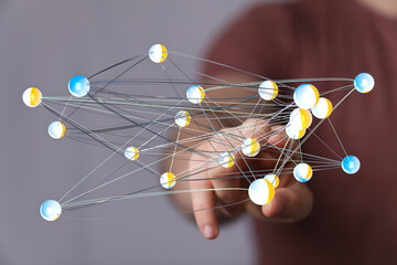 Abstract image of a network structure touched by a hand, symbolizing connection and digital communication.