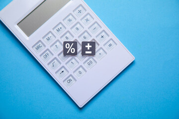 Percent symbol with a calculator on the blue background.