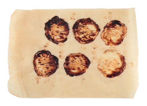 Kitchen parchment sheet with baked meat patty stains, isolated on transparent background. Realistic cooking texture for food design, recipe mockups, and culinary projects
