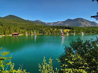 Lake Walchensee, an alpine lake in Upper Bavaria with turquoise water and sailboats in summer
