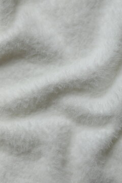 White cashmere fabric background. Top view