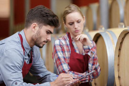 professional winery worker in wine cellar - Powered by Adobe