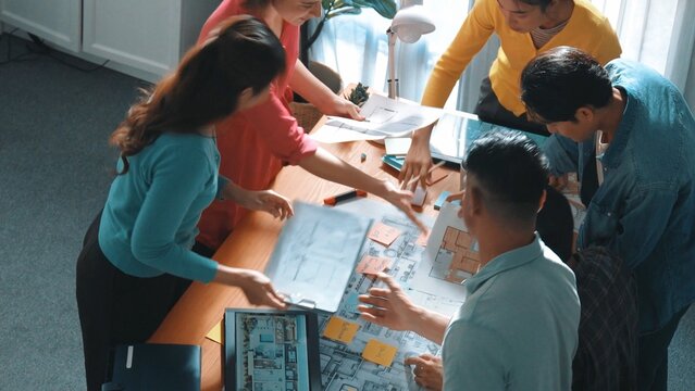 Top view of smart civil engineer team working together to plans building construction. Top view of architect designer walking and joining meeting while talking idea while looking at tablet. Symposium. - Powered by Adobe