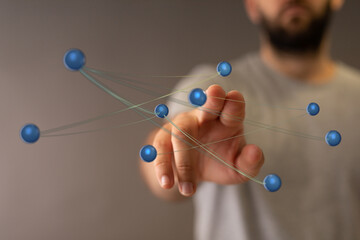 Concept of connection, interaction, and data representation. Hand touching a virtual network of spheres represe