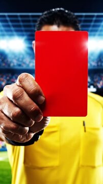 Football / soccer referee shows a red card directly to the camera, staring with anger and authority.