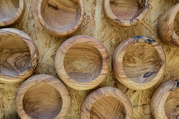 Wooden bowls arranged on a natural wooden surface showcasing fine craftsmanship, ideal for serving food or decorative purposes, created in a traditional workshop environment