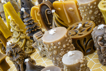 Colorful handmade candles displayed at a local market during the afternoon, showcasing various shapes and textures