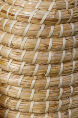 Close-up view of a handcrafted woven basket made from natural materials, showcasing unique patterns and craftsmanship in traditional weaving style
