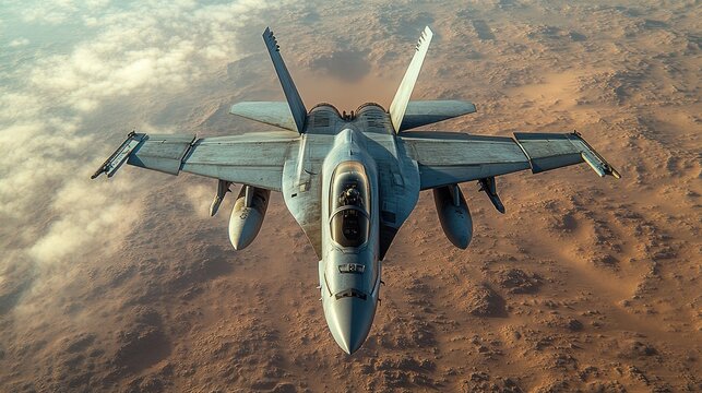 Military jet soaring above desert landscape during clear daytime sky