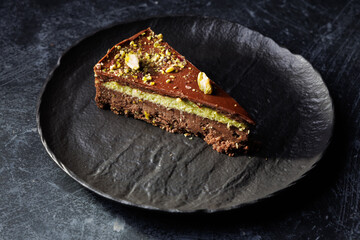 Rich Chocolate Cake Slice With Pistachio Cream Layer And Nut Crumble