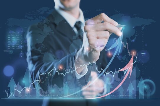 Businessman analyzing trading graph, finance background.
