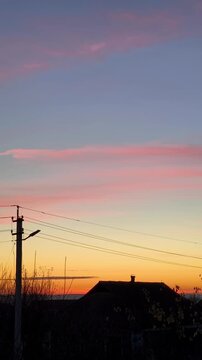 A view of a sunset with a house in the background