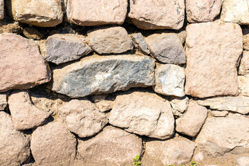 Obraz premium A natural stone masonry wall, background.