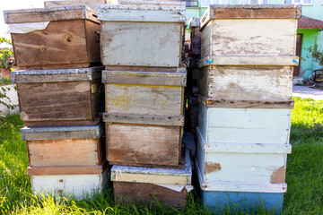 Old wooden beehives stacked, close-up.