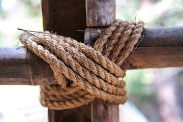 knotted rope on a wooden pole in close up © Erich