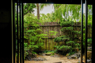 Fototapeta premium Traditional Japanese house home or ryokan restaurant with sliding paper shoji doors and view natural garden,restaurant or hotel interior.
