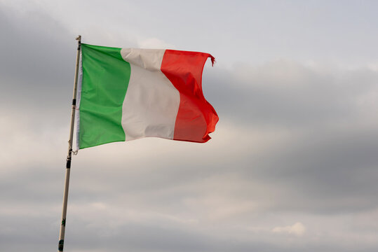 Flag of Italy against the blue sky.
