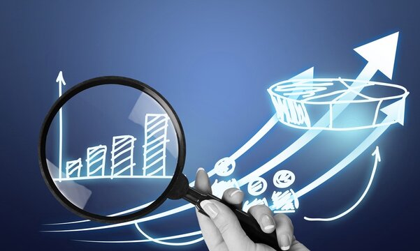 A magnifying glass over abstract financial chart,