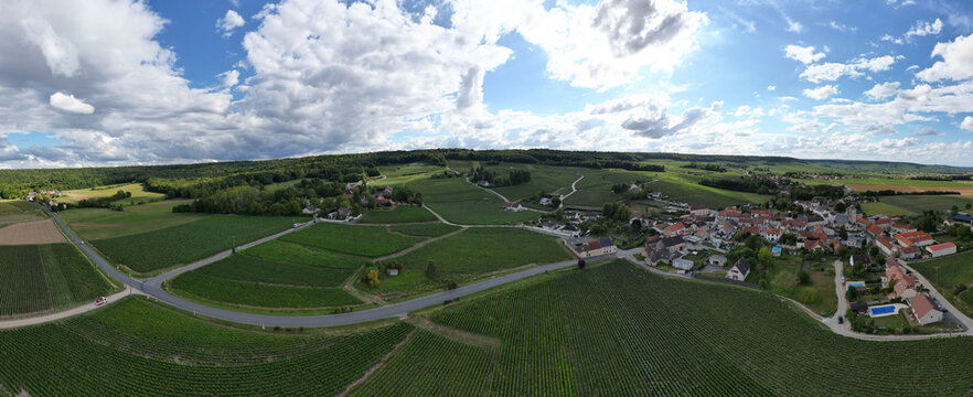 Trois-Puits, Reims, Marne, Grand-Est, France, August, 28th, 2025, Champagne Area, Stunning aerial view showcasing lush green vineyards and picturesque countryside under a backdrop of dramatic clouds