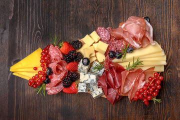 Party charcuterie board italian food antipasti prosciutto ham, salami and cheese appetizers served...