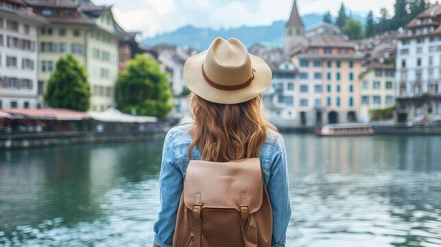 Woman exploring charming European riverside town.  Travel, adventure, summer vacation imagery
