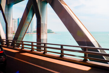 cars driving on the bridge road over sea,Highway traffic jam,rush hour,public transport.	