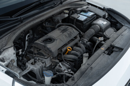Wroclaw, Poland - October 29, 2025: Open engine bay of a compact car, revealing a used four-cylinder petrol engine and components ready for inspection or service.