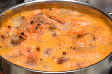Close up shrimp in a metal pot with boiling water.