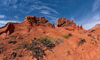 Northern Kyrgyzstan. Picturesque views of the famous Skazka Canyon, the clay mountain peaks of which have bright colors from yellow to red-brown.