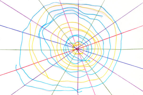 Colorful knitting threads in a shape of a spider web