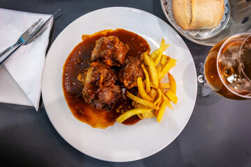 Spanish bull tail stew rabo de toro with potatoes, served in a restaurant in Cordoba, Andaluzia. Spanish bull tail stew rabo de toro, spanish cuisine