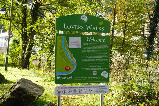 Informational Sign For Lovers' Walks And Derwent Gardens In Matlock Bath, Derbyshire, England, With Historical Details And A River Path Map.