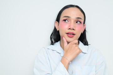 Portrait of a young Thai transgender person thinking against white background