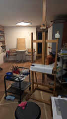 Creative workspace with easel and art supplies in cozy artist's studio setting