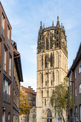 Fototapeta premium A gothic church building with numerous ornaments on a street in the city of Munster, Germany Liebfrauen Uberwasserkirche