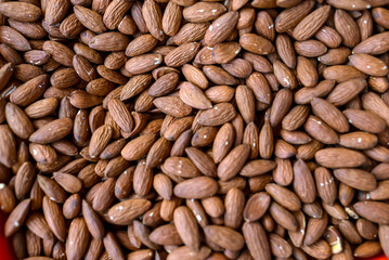 Shelled almonds forming a textured backdrop of healthy food