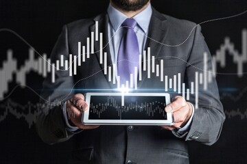 Businesswomen use digital tablet with stock markets