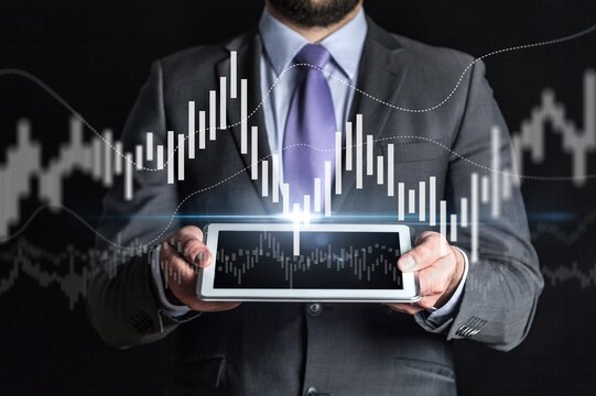 Businesswomen use digital tablet with stock markets