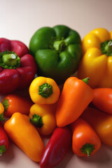 vibrant array of fresh red, yellow, orange, and green bell peppers in natural light on soft neutral background highlighting their glossy textures and organic bounty, neutral, unprocessed, array