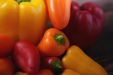 vibrant close-up image showcasing array of colorful bell peppers and tomatoes with rich textures and contrasting hues, highlighting natural freshness and organic appeal, bounty, richness, saturation
