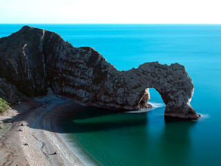 Extremely long exposure of Durdle door, a World heritage site, Dorset.Ghostly figures on beach