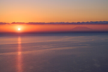 Minimalist sunset over the Aegean with Mount Athos on the horizon and a glowing sun path. Ideal for: travel campaigns, wellness visuals, meditation apps, coastal posters.