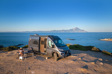 Camper van parked on a coastal cliff facing Mount Athos and the calm Aegean. Ideal for: vanlife...