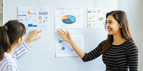 Business team analyzing data and marketing strategy in modern office, brainstorming ideas for project success using laptops and charts, teamwork collaboration for corporate growth