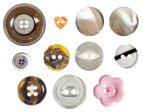 Isolated photo of various colored and shaped plastic and nacre decorative cloth buttons or rivets on white background.