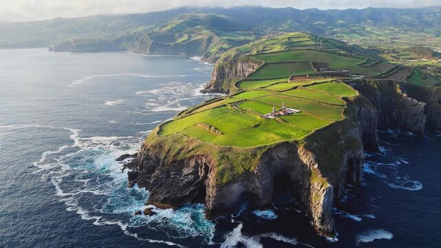 Aerial drone shot of Cape Cintrao with lighthouse on high cliff Atlantic ocean coast Sao Miguel island Azores